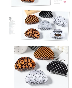 Detail showing various Halloween claw clips with pumpkin and spider web patterns
