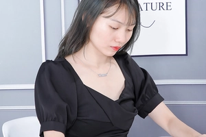 Silver Cancer zodiac word pendant necklace shown on a model with a black dress