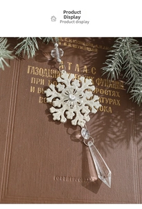 Close-up of silver glitter snowflake ornament with acrylic water drop pendant and clear beads