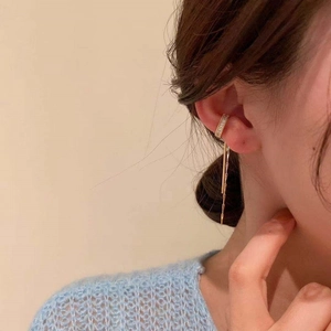 Gold-plated C-shaped ear cuff with long tassels and sparkling cubic zirconia stones