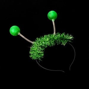 Detail of green alien headband with bouncy spring balls and shiny metallic tinsel
