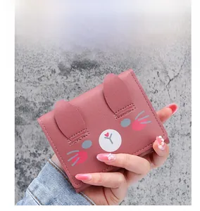 Detailed close-up of a pink cartoon wallet featuring a sweet animal ear design