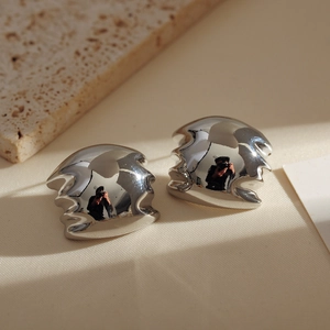 Minimalist silver irregular lava texture earrings with a high-polished metallic finish