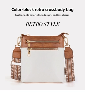 Detail view of vintage contrast leather crossbody bag with dual zippers and wide strap