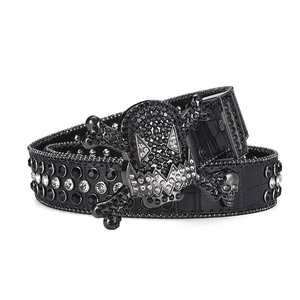 Detail of gothic skull buckle belt with crocodile texture and sparkling rhinestones