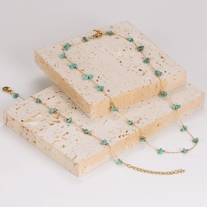 Gold chain necklace and bracelet set featuring natural turquoise stones on stones