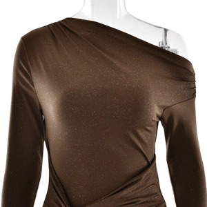 Detail of shimmer fabric and waist ruching on this brown one-shoulder long sleeve dress