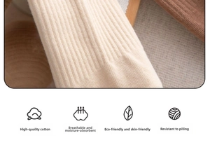 Macro shot of cream ribbed knit cotton fabric showing soft texture and premium weave