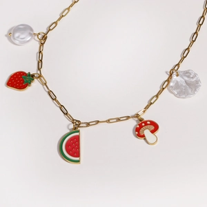 Detail of titanium steel necklace with fruit charms like strawberry and watermelon