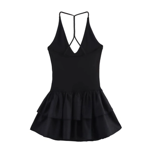 Detailed view of women's black dress featuring Y-back cross straps and tiered ruffles