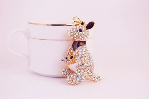 Detail of kangaroo keychain with colorful rhinestones on a pink background