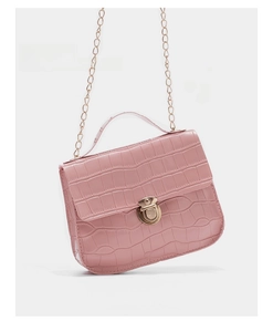 Detailed view of pink crocodile embossed leather texture with gold chain strap on small bag