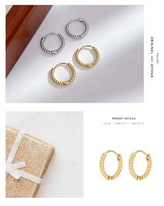 Detail of twisted rope stainless steel hoop earrings in gold and silver finish