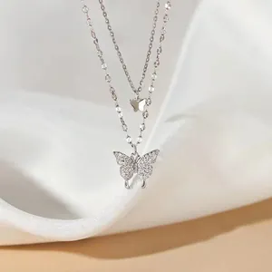 Macro detail of a double-layered butterfly pendant necklace with sparkling zircons