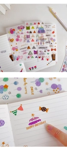 Macro detail of translucent washi stickers with balloons and birthday themes on a notebook