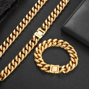 Detail of interlocking gold Cuban link necklace and bracelet set with box clasp