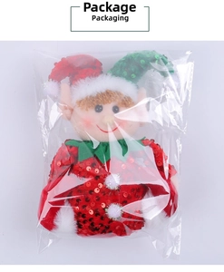 Christmas elf doll with red sequins and green collar in clear plastic packaging
