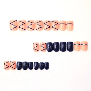 Short square press-on nails set with navy blue and pink geometric rhinestone designs