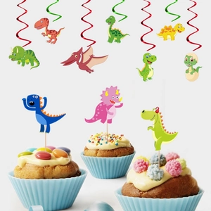 Dinosaur themed party decorations with colorful spiral hanging swirls and cupcake toppers