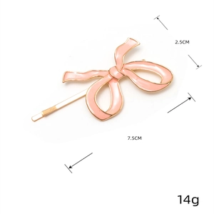 Pink enamel bow hair clip with gold metal trim and dimensions 2.5CM x 7.5CM