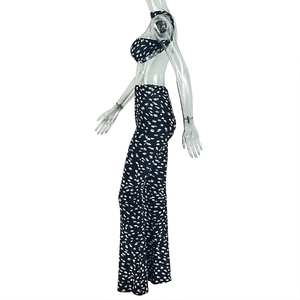 Detail view of printed two-piece set featuring backless halter top and high-waist pants