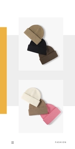 Flat lay of knit beanies in multiple colors including black, brown, beige, and pink tones
