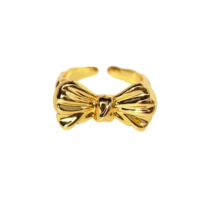 Minimalist gold-plated brass open ring featuring a 3D bowknot design on white background