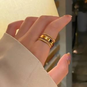 Minimalist adjustable gold-plated stackable ring set with twist and smooth band designs