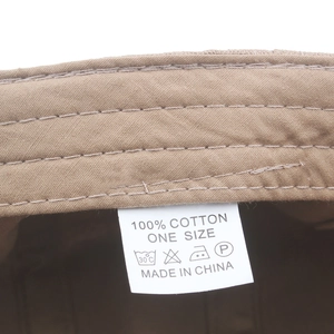 Internal view of khaki cotton newsboy cap showing 100% cotton label and stitching
