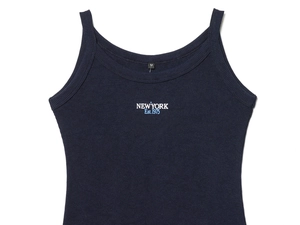 Detail of navy blue ribbed crop top with New York Est.1975 print and soft knit texture