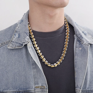 Detail of two-tone gold and silver punk style dragon bone chain necklace for men