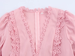 Detail of pink dress back featuring lace patchwork, invisible zipper, and chiffon texture