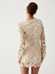 Elegant beige crochet mini dress with intricate swirl knit patterns and long sleeves