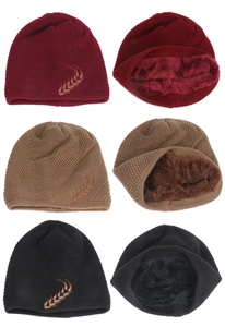 Detail of warm knit beanies with wheat embroidery and thick faux fur lining inside