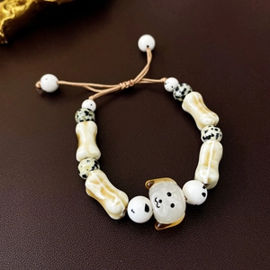 Macro shot of ceramic beads and dog charm on a dark leather surface with details