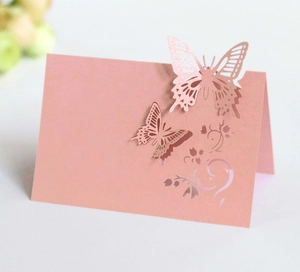 Macro view of 3D laser-cut butterfly place card in elegant pearlescent pink cardstock