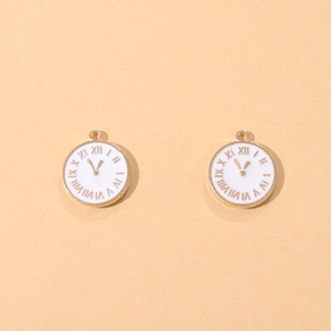 Close-up of golden clock-face charms with white enamel and Roman numeral details