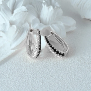 Detail view of S925 sterling silver huggie earrings with black and clear double row stones