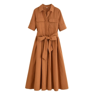 Detail of a brown poplin shirt dress with button-front, chest pockets, and matching belt