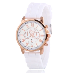 Detail of rose gold quartz watch with white silicone strap and Roman numeral dial face