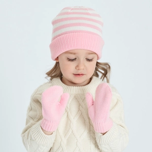 Detail of pink and white striped knit beanie and solid pink mittens on a child model
