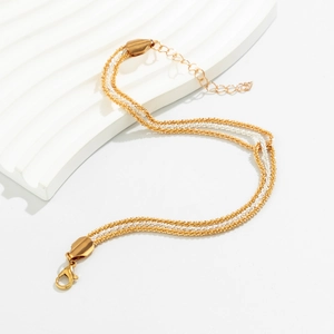 Detail of gold and silver braided chain necklace with lobster clasp and extender