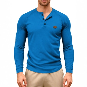 Men's blue waffle knit long sleeve Henley shirt with buttoned collar and chest patch