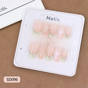 Elegant green French press-on nails with white flowers, pearls, and glitter on 10pc display card