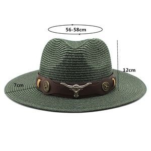 Detail view of green straw cowboy hat with leather band and metal bull head ornament