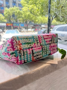 Detail of canvas bag featuring floral foam print and Boracay lettering in natural light