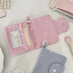 Detail of pink fabric coin purse featuring silver stars, zipper pocket and card slots