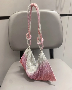 Detail of pink and silver gradient rhinestone hobo bag featuring a stylish knotted handle
