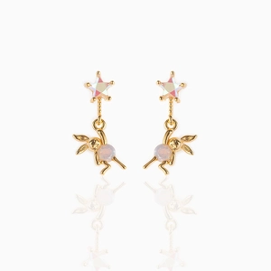 Detail of 18K gold dangling earrings featuring stars and cute rabbit charms with pink gems