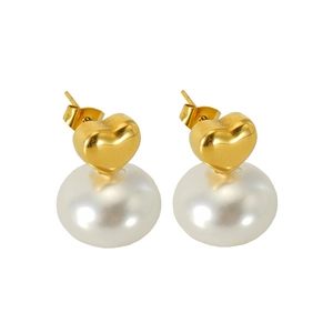 Close-up of golden heart earrings with white pearls in a French vintage style